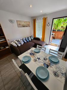 a living room with a table and a couch at Przystanek Żarnowska Domki in Żarnowska +24 photos