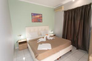 a bedroom with a bed with two stuffed animals on it at Oliva Resort View & Swimming pool Studios in Parga