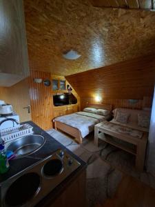 a bathroom with a bed and a sink in a room at Apartment VUK in Žabljak