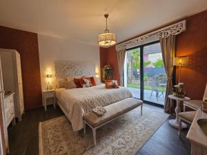a bedroom with a bed and a large window at La Villa M77 in Boitron +89 photos