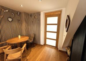 a dining room with a table and chairs and a door at Spa Privatif Montataire in Montataire +15 photos