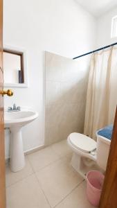 a bathroom with a toilet and a sink at Casa Bugambilias in Tenosique de Pino Suárez