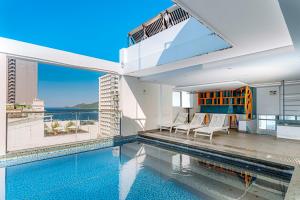 a house with a swimming pool with a view of the ocean at Rico hotel Nha Trang in Nha Trang