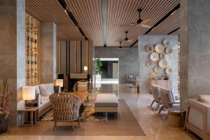 a living room with a table and chairs and a lobby at Radisson Blu Resort, Phuket Mai Khao Beach in Mai Khao Beach +140 photos