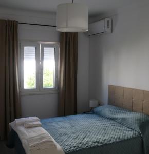 a bedroom with a bed and a window at Refúgio Viçoso in Vila Viçosa +29 photos