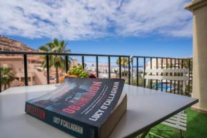a book sitting on top of a table on a balcony at Noemi Blu Tenerife in Los Cristianos