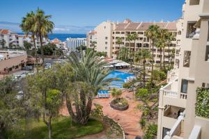 an aerial view of a resort with a pool and palm trees at Noemi Blu Tenerife in Los Cristianos