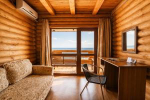 a room with a couch and a desk with a window at Ensenada in Gribovka