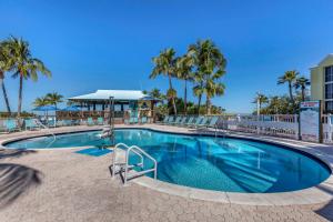 a swimming pool at a resort with palm trees at Bluegreen Vacations Hammocks at Marathon, Ascend Collection Resort in Marathon