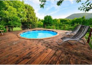 a patio with a pool and a chair on a deck at Guesthouse Mirko Hodak in Seliste Dreznicko