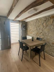 a dining room with a wooden table and chairs at Earra - Salegi - 2 minutos playa in Zarautz