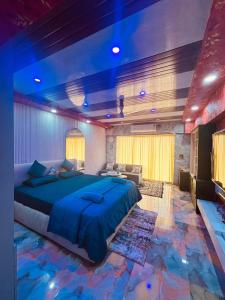 a bedroom with a large bed in a room with a fish floor at weston Hotel And Resorts in kolkata +23 photos