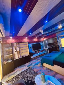 a room with a bed and a tv in it at weston Hotel And Resorts in kolkata