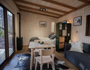 a room with a table and a bed and a couch at Tagua Cabins Malalcahuello in Malalcahuello