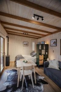 a living room with a table and a couch at Tagua Cabins Malalcahuello in Malalcahuello