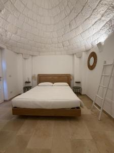 a bedroom with a bed and a white ceiling at Trulli Dafani in Ostuni +62 photos