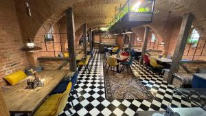 a restaurant with tables and chairs and a checkered floor at Hotel Stork in Lednice +153 photos