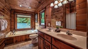 a bathroom with two sinks and a tub and a toilet at Among the Trees in Epworth +58 photos