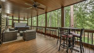 a screened in porch with a table and chairs at Among the Trees in Epworth