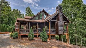 a large wooden house in the woods at Living Waters in Blue Ridge