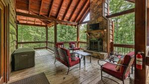 a screened in porch with chairs and a fireplace at Living Waters in Blue Ridge