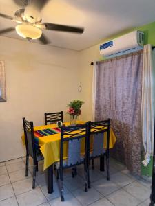 a dining room with a yellow table and chairs at Excente alojamiento in Zaragoza +3 photos