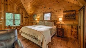a bedroom with a bed in a wooden cabin at Living Waters in Blue Ridge