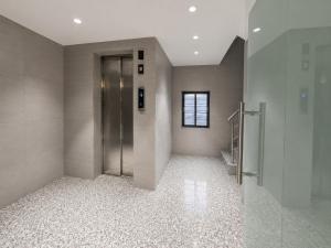 a hallway with a metal elevator in a building at The Bay Suites - MMR in New Town