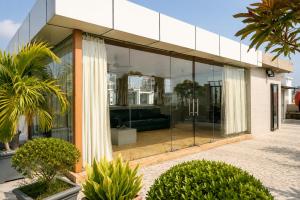 a glass building with a couch inside of it at The Bay Suites - MMR in New Town +35 photos