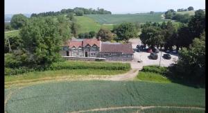 an aerial view of a house in a field at The Hunters Rest Inn in Clutton