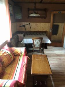 a living room with a couch and a table at cozy alpine house in Breitenstein