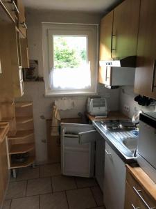 a small kitchen with a sink and a window at cozy alpine house in Breitenstein +18 photos