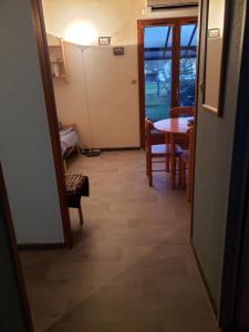 a hallway with a table and a dining room at Maison in Camiers +2 photos