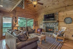 a living room with a couch and a fireplace at Black Bear Lodge in Blue Ridge