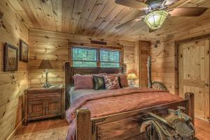 a bedroom with a bed in a log cabin at Black Bear Lodge in Blue Ridge