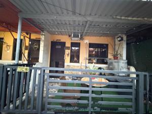a porch of a house with a fence at My Humble Home in Dipolog +5 photos