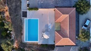 an overhead view of a house with a swimming pool at Ionian Harmony Luxury Villas in Tsoukalades