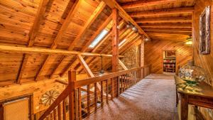 a staircase in a log cabin with a wooden ceiling at Falling Waters in Blue Ridge