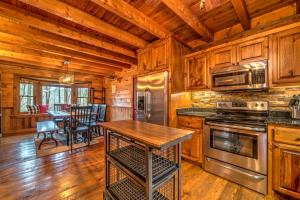 a kitchen with wooden cabinets and a table in a cabin at Falling Waters in Blue Ridge