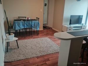 a living room with a table and a dining room at M&L departamento in Limache