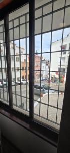 a window with a view of a city street at Havana Hostel in Albufeira