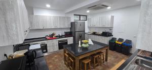 a kitchen with a refrigerator and a table in it at Havana Hostel in Albufeira