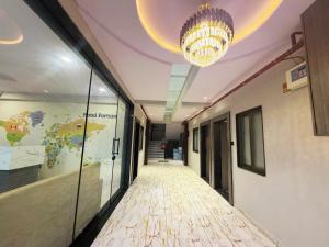 a hallway in an office with a chandelier at Hotel Fortune, Althan in Surat