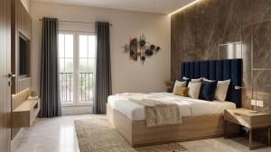 a bedroom with a large bed with a blue headboard at Hotel Prime Fine in Agra