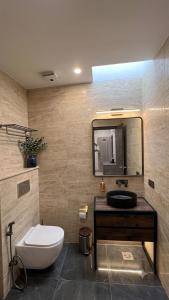 a bathroom with a toilet and a sink and a mirror at Hotel Prime Fine in Agra