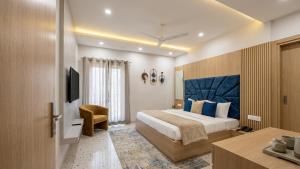 a hotel room with a bed and a television at Hotel Prime Fine in Agra