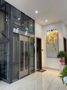 an entrance to a building with a painting on the wall at Vin Luxury Hotel in Quang Tri