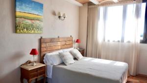 a bedroom with a white bed and a window at Can 28 in Torroella de Montgrí +30 photos