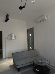 a living room with a couch and a glass table at Slow Living Home in Kilada