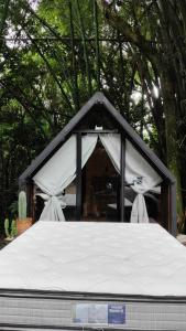 a black and white tent with a mattress at Cabana recanto da TOCA in Ilhabela